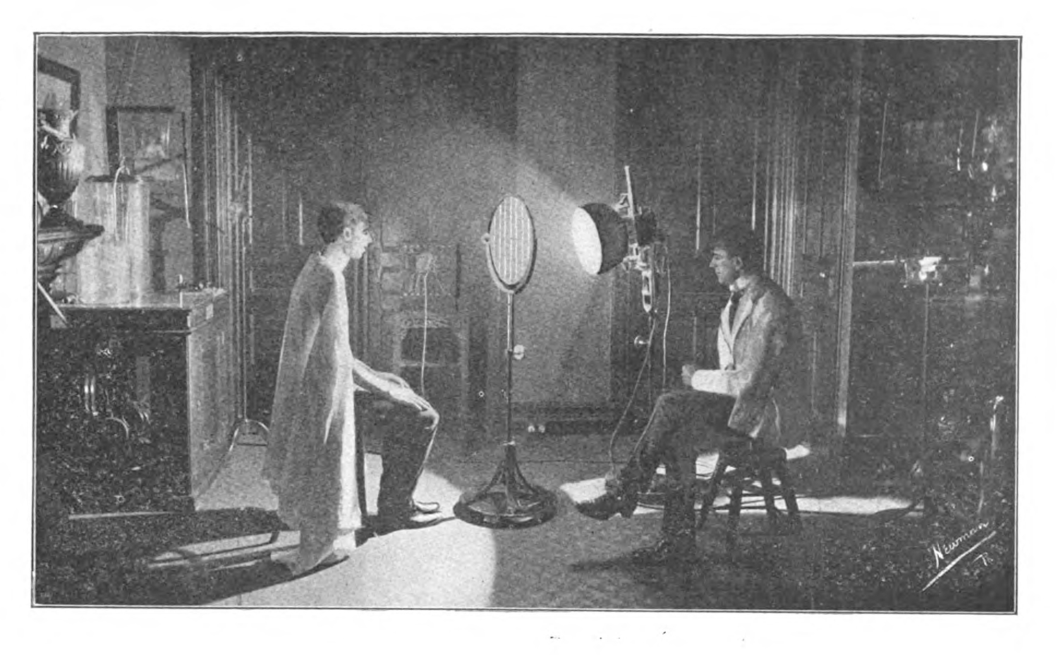 An example of phototherapy. A shrouded patient stands in front of a powerful light while a doctor looks on.