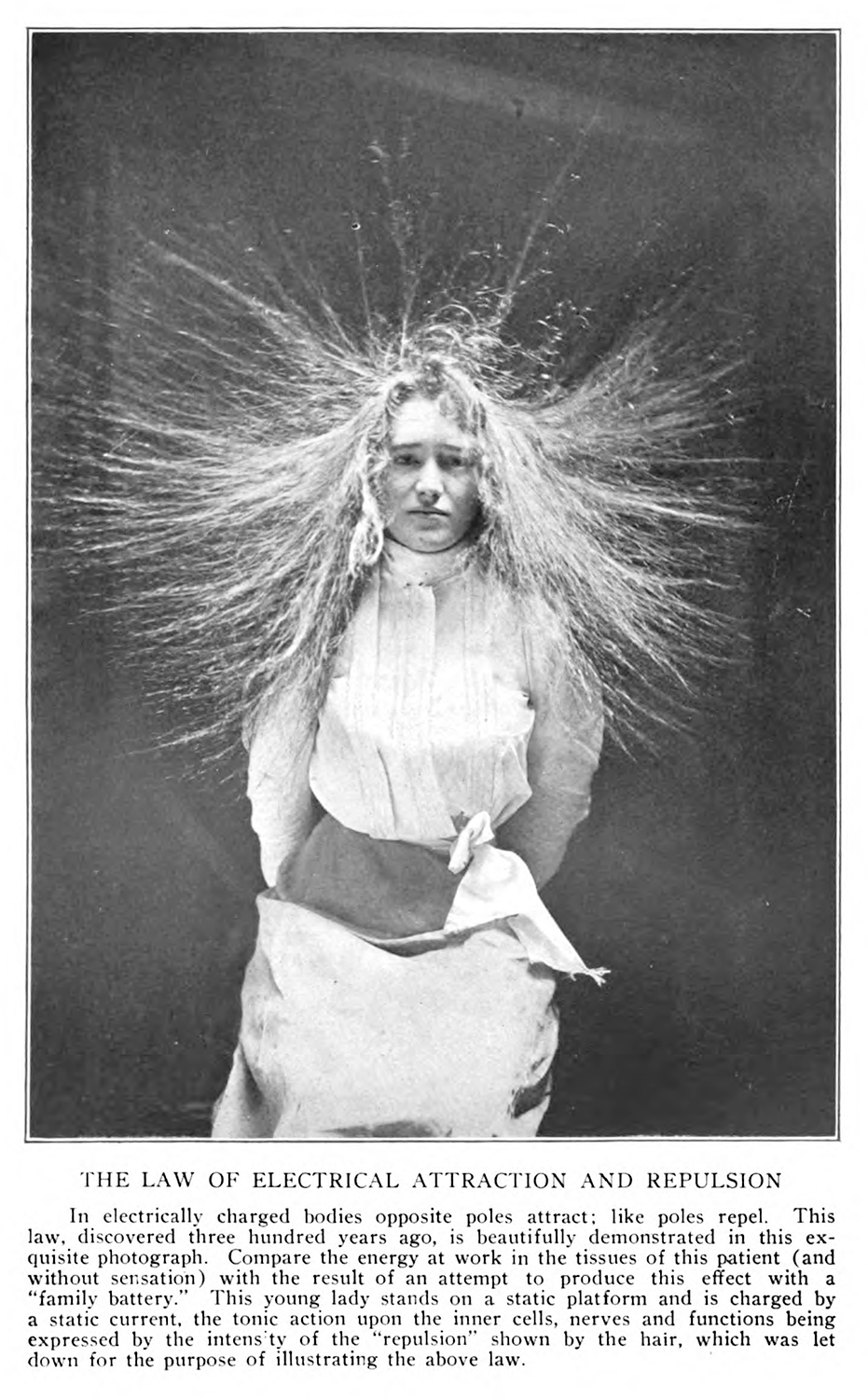 An example of electrotherapy. A woman sits with her arms crossed and her hair standing up from the electric current.